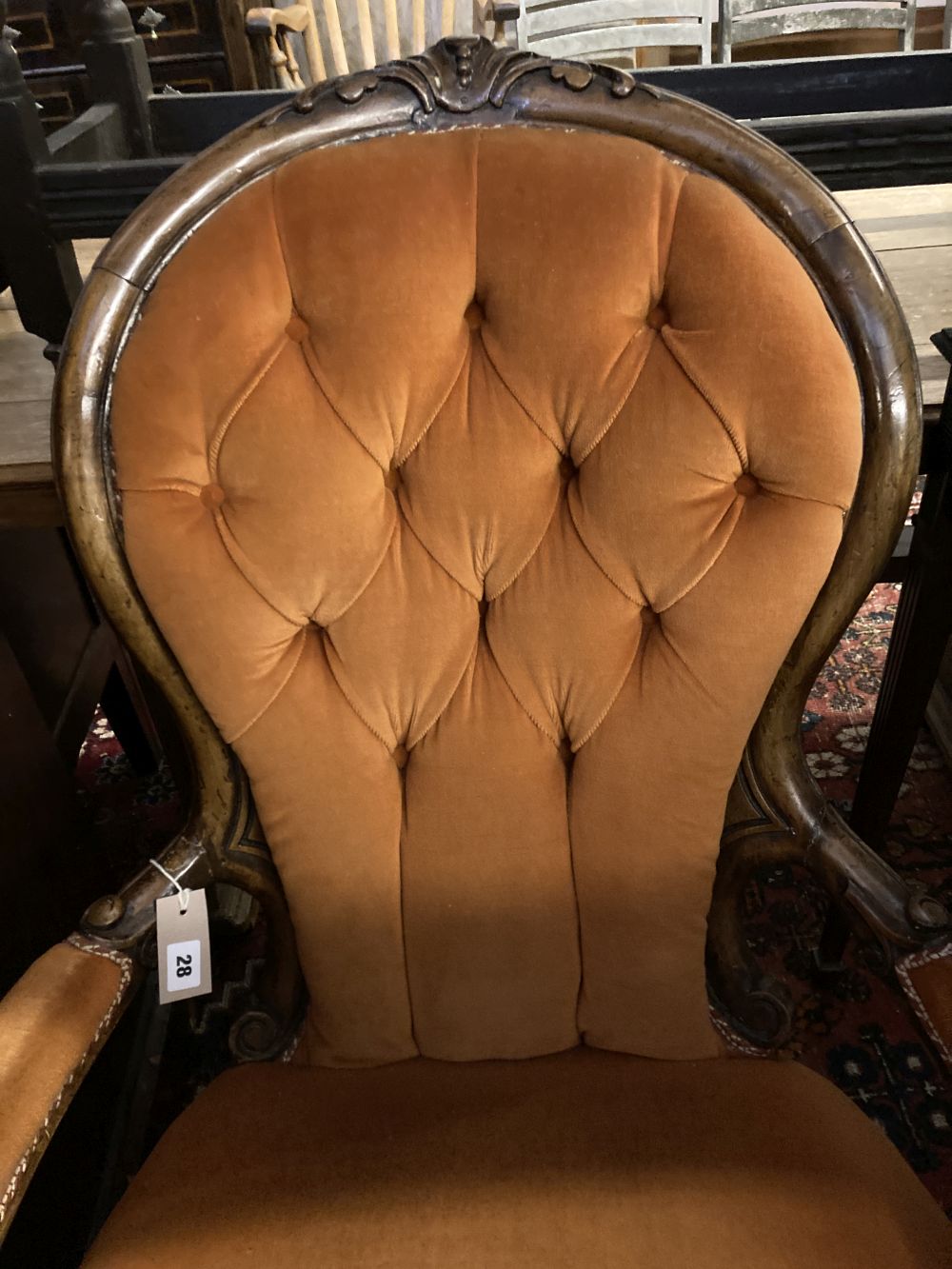 A Victorian walnut spoonback open armchair, width 66cm, depth 80cm, height 90cm